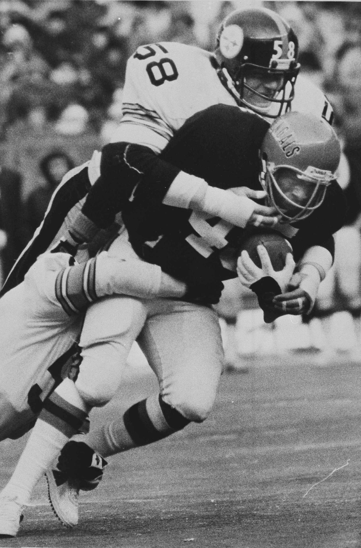 Steelers linebacker Jack Lambert tackles Bengals running back Archie Griffin during a game in 1977.