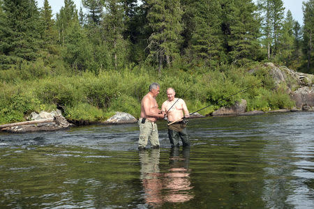 Russian President Vladimir Putin and Defence Minister Sergei Shoigu fish during the hunting and fishing trip which took place on August 1-3 in the republic of Tyva in southern Siberia, Russia, in this photo released by the Kremlin on August 5, 2017. Sputnik/Alexei Nikolsky/Kremlin via REUTERS