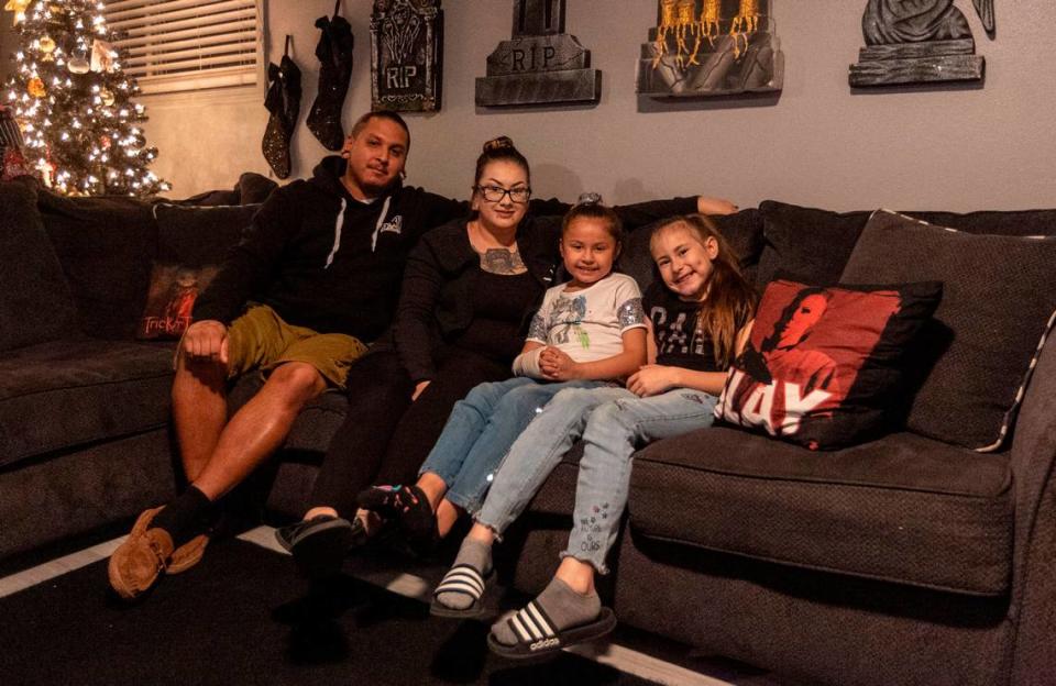 Jonathan Saldana and Krystal Tiscareno sit with their daughters, Rozay, 7, and Lyric, 8, in their Richland home. The family contracted COVID in August and recovered. Then Rozay developed MIS-C.