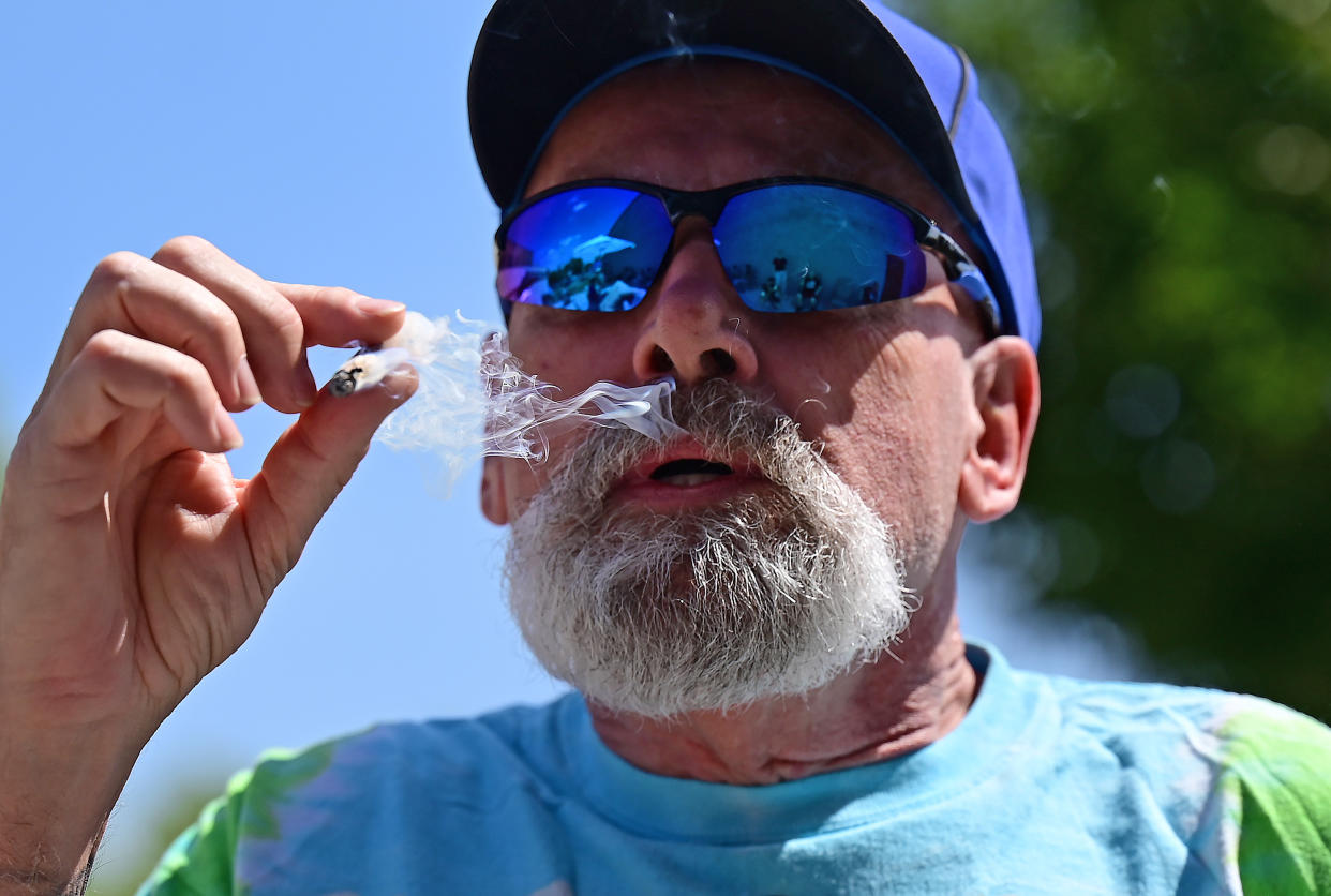 Randy Schroeder smokes during a marijuana legalization celebration.
