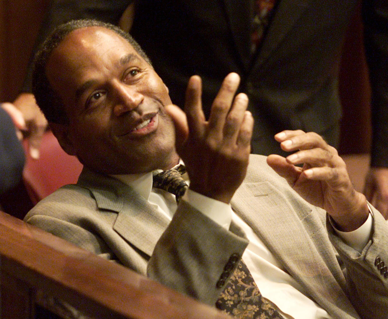 Former NFL star O.J. Simpson talks to a person in the gallery before
the start of the third day of jury selection in his 