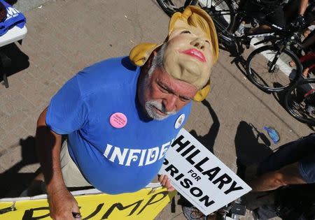 A protester wears a mask depicting Democrat U.S. presidential candidate Hillary Clinton outside the arena hosting the Republican National Convention in Cleveland, Ohio, U.S. July 20, 2016. REUTERS/Lucas Jackson