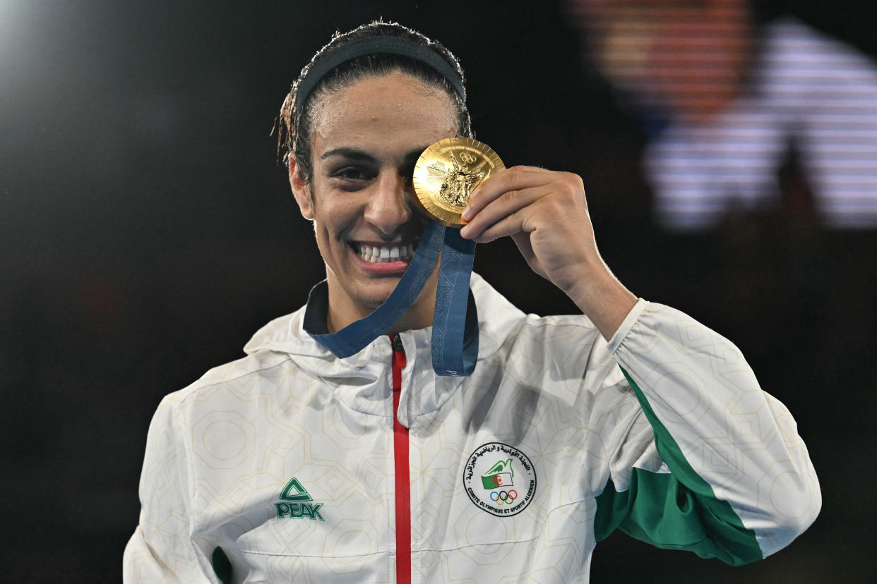 TOPSHOT - Gold medallist Algeria's Imane Khelif poses on the podium during the medal ceremony for the women's 66kg final boxing category during the Paris 2024 Olympic Games at the Roland-Garros Stadium, in Paris on August 9, 2024. (Photo by MOHD RASFAN / AFP) (Photo by MOHD RASFAN/AFP via Getty Images)