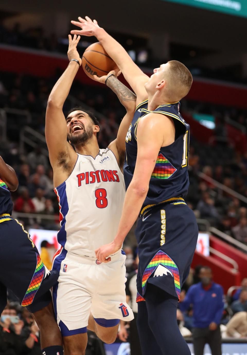 Detroit Pistons forward Trey Lyles (8) is fouled by Denver Nuggets center Nikola Jokic (15) Tuesday, Jan. 25, 2022 at Little Caesars Arena.