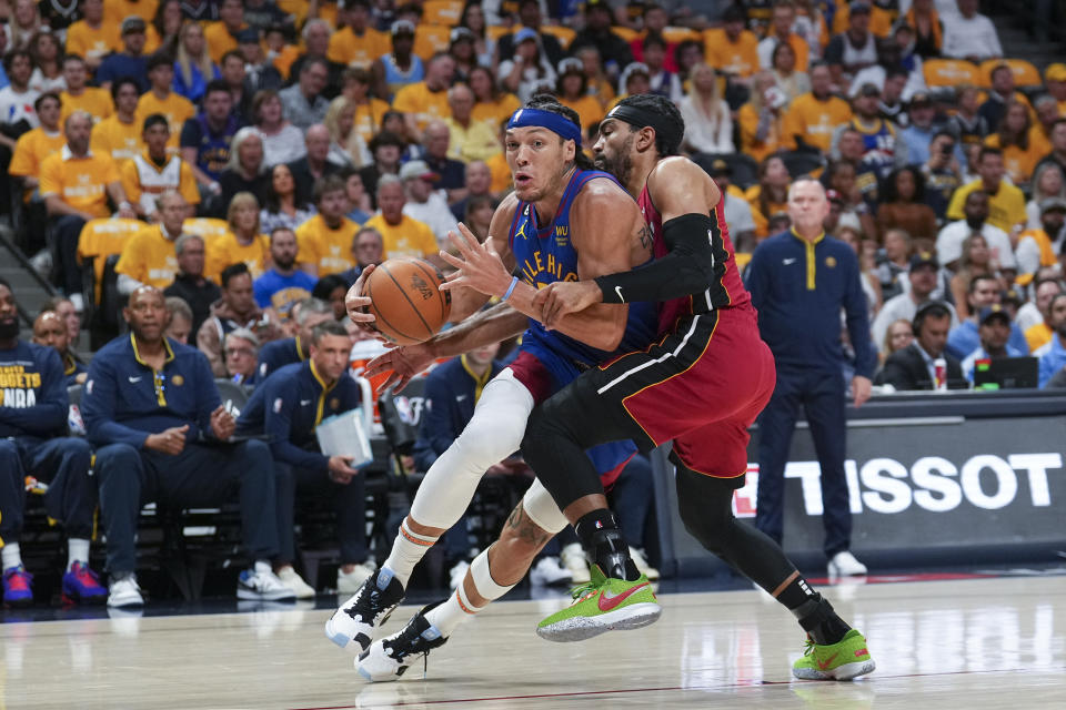 Denver Nuggets forward Aaron Gordon, left, tries to get past Miami Heat guard Gabe Vincent during the first half of Game 1 of basketball's NBA Finals, Thursday, June 1, 2023, in Denver. (AP Photo/Jack Dempsey)