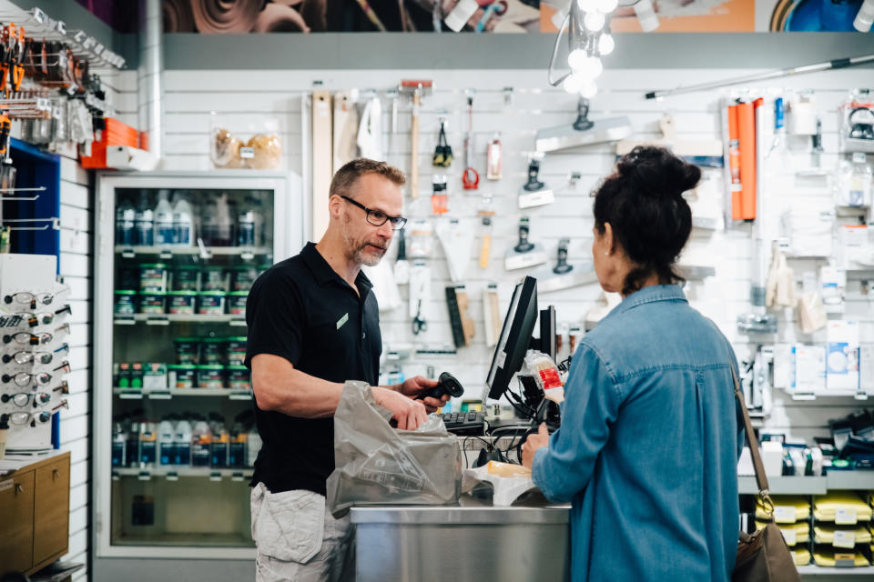 A clerk helping a woman in a hardware store