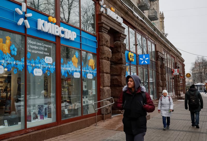 People walk past a Kyivstar store in Kyiv