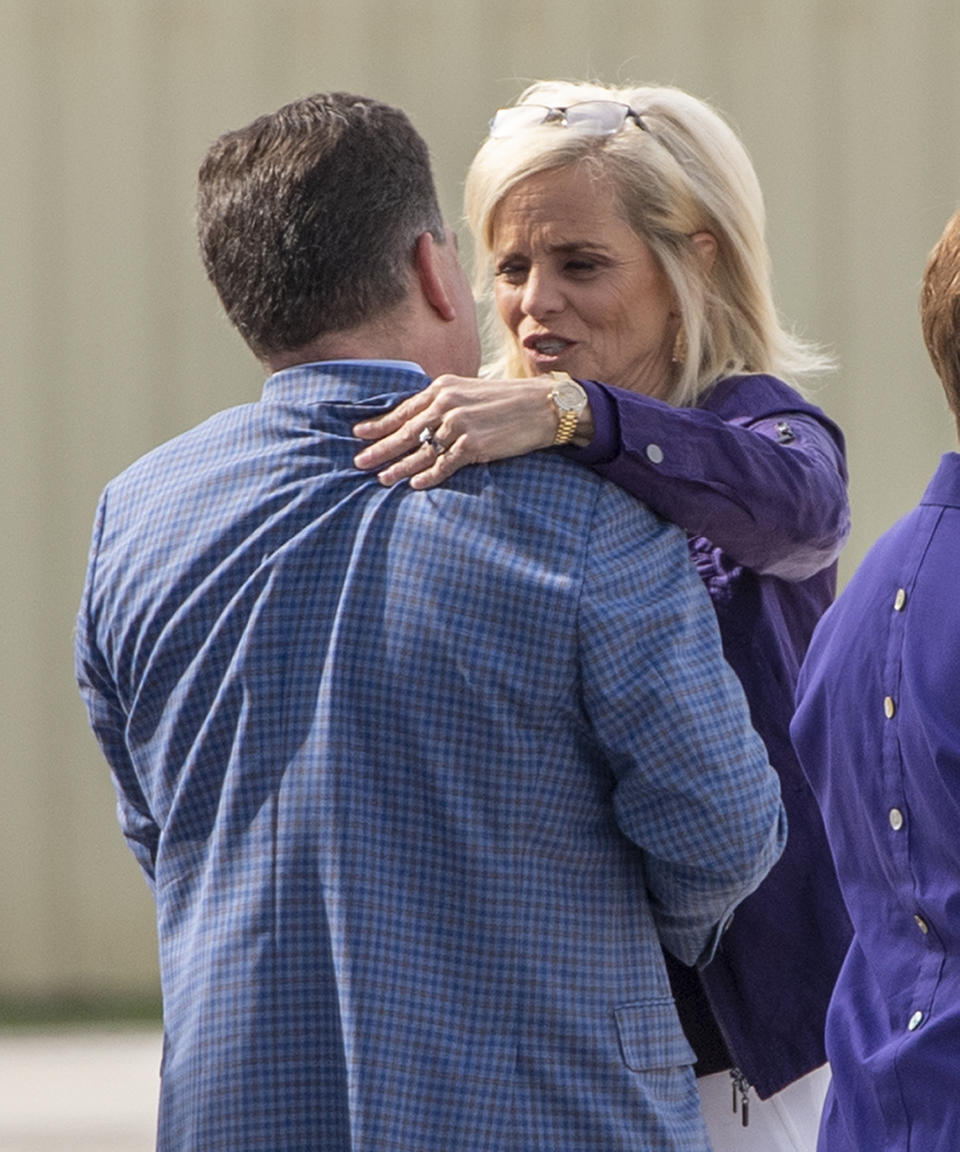 Speaking to Athletics Director Scott Woodward, left, former Baylor women's basketball coach Kim Mulkey arrives at Metro Airport to become LSU's women's basketball coach Monday, April 26, 2021, in Baton Rouge, La. (Bill Feig/The Advocate via AP)