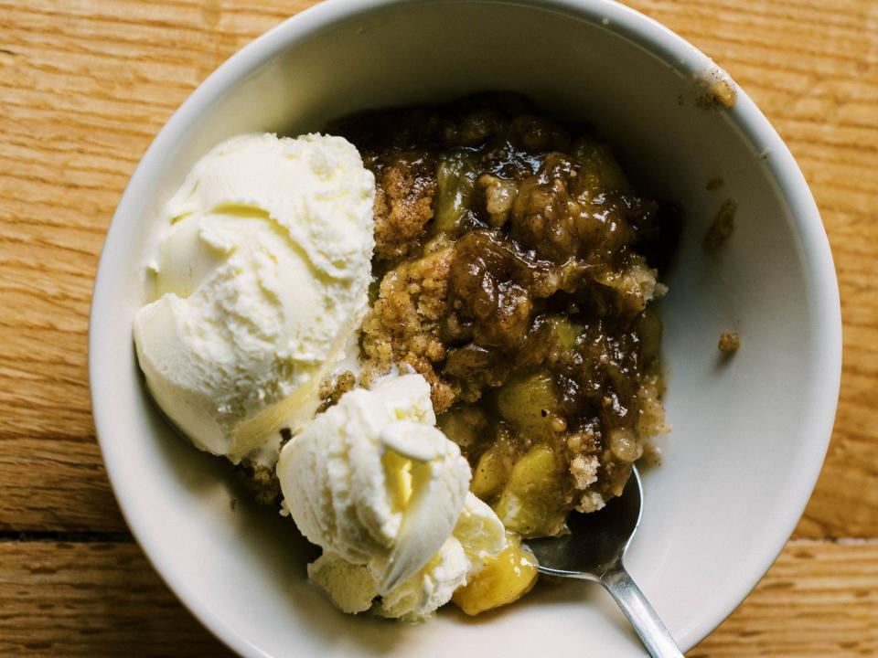 Peach cobbler with ice cream on top.