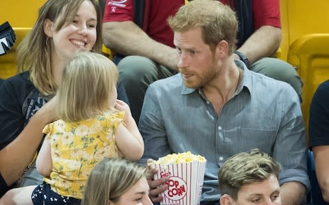 TORONTO, ON - SEPTEMBER 27: Prince Harry (R) sits with David Henson's wife Hayley Henson (L) and daugther Emily Henson at the Sitting Volleyball Finals on day 5 of the Invictus Games Toronto 2017  - Credit: Samir Hussein/WireImage