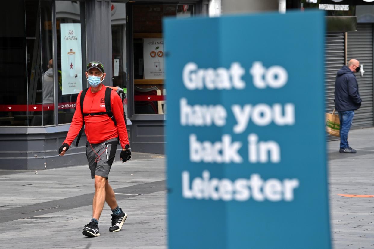 Shoppers wearing PPE (personal protective equipment), of a face mask or covering as a precautionary measure against spreading COVID-19, walk in the city centre of Leicester, central England, on June 30, 2020. - Britain on Monday reimposed lockdown measures on a city hit by an outbreak of coronavirus, in the first big test of Prime Minister Boris Johnson's "whack-a-mole" strategy to control the disease while getting the economy moving again. (Photo by JUSTIN TALLIS / AFP) (Photo by JUSTIN TALLIS/AFP via Getty Images)