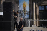 Workers prepare loudspeaker for the arrival of the Olympic flame in the Old Port of Marseille in southern France, Tuesday, May 7, 2024. The Olympic torch will finally enter France when it reaches the southern seaport of Marseille on Wednesday. (AP Photo/Daniel Cole)