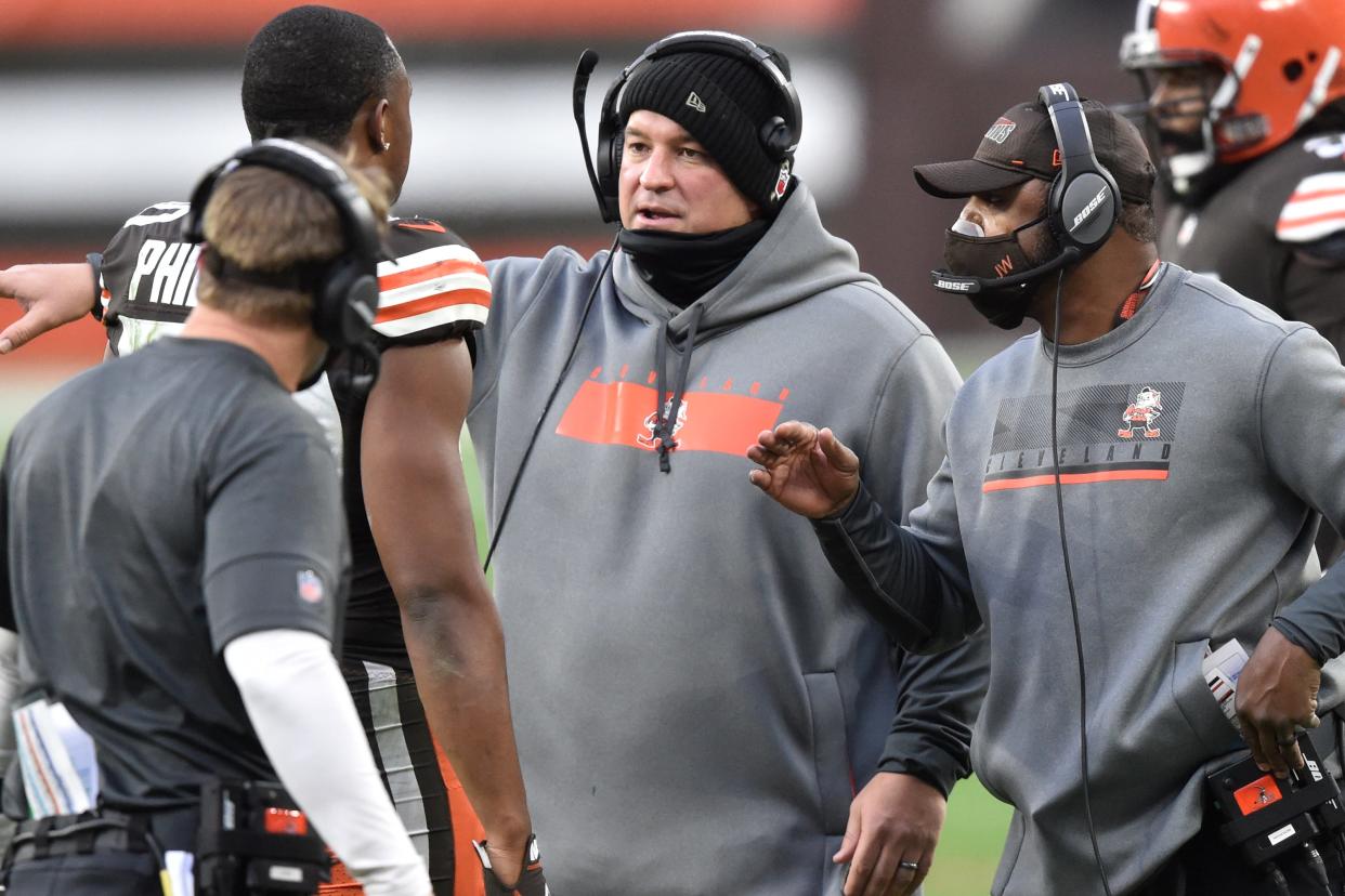 Browns defensive coordinator Joe Woods, right, and defensive line coach Chris Kiffin, center, talk to linebacker Jacob Phillips during a game against the Steelers, Sunday, Jan. 3, 2021, in Cleveland. The Browns won 24-22. (AP Photo/David Richard)