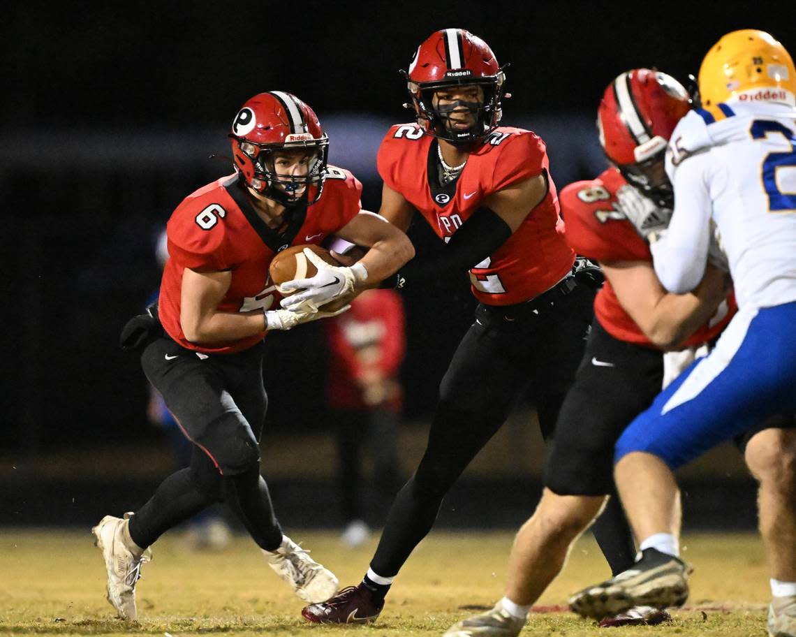 FPD quarterback Jakhari Williams (2) hands off the ball to running back Hayden Aulds (6) Friday night against Tattnall. Donn Rodenroth\ For The Telegraph