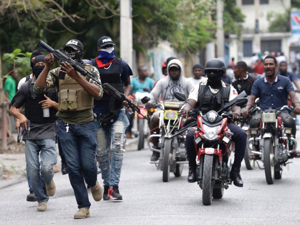 Armed off-duty police officers protest over pay and working conditions, in Port-au-Prince, Haiti, Sunday, Feb. 23, 2020.