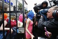 Masked members of Pussy Riot leave a police station in Adler during the 2014 Sochi Winter Olympics, February 18, 2014. REUTERS/Shamil Zhumatov