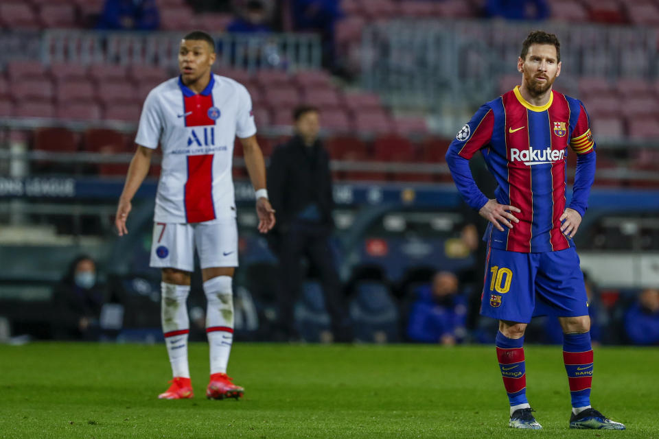 Lionel Messi (derecha) del Barcelona y Kylian Mbappé del PSG durante el partido por los octavos de final de la Liga de Campeones, el martes 16 de febrero de 2021. (AP Foto/Joan Monfort)