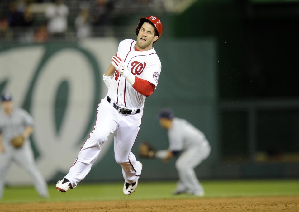 Washington Nationals left fielder Bryce Harper runs towards third with a three RBI triple during the third inning of a baseball game against the San Diego Padres, Friday, April 25, 2014, in Washington. (AP Photo/Nick Wass)