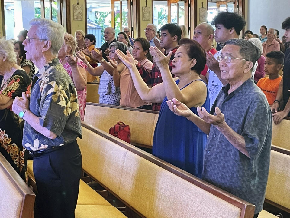 Parishioners attend Mass at Sacred Hearts Mission Church in Kapalua, Hawaii, Sunday, Aug. 13, 2023. Sacred Hearts Mission Church hosted congregants from Maria Lanakila Catholic Church in Lahaina, including several people who lost family members in fires that burned most of the Maui town days earlier. (AP Photo/Haven Daley)