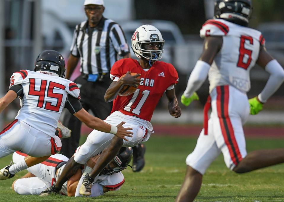 Vero Beach High School's E.J. White sprints into South Fork defenders in the first quarter as the Vero Beach High School Fighting Indians take on the South Fork Bulldogs on Friday, Aug. 26, 2022, at Billy Livings Field at the Citrus Bow in Vero Beach. Vero Beach won 54-6.  