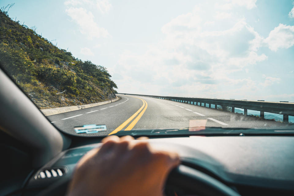 A person driving a car on a road trip