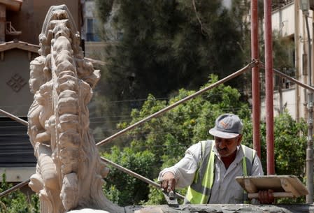 An Egyptian worker carries out restoration work of the Baron Empain Palace, "Qasr el Baron" or The Hindu Palace, built in the 20th century by Belgian industrialist Edouard Louis Joseph, also known as Baron Empain, in the Cairo's suburb Heliopolis