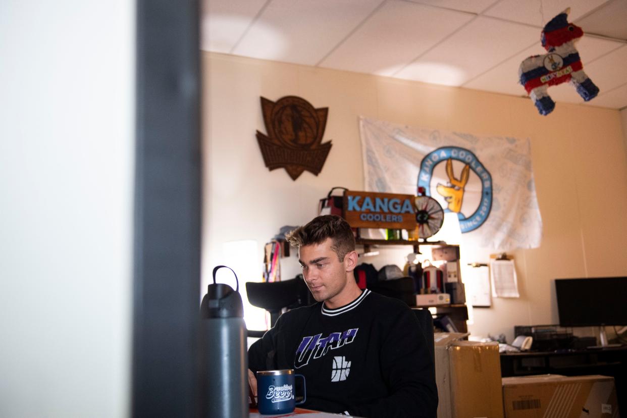 Billy Howard, events and licensing manager at Kanga Coolers, works in his office at the facility in Greenville on Monday, Dec. 18, 2023.