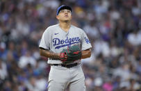 Los Angeles Dodgers starting pitcher Julio Urias reacts after givng up an RBI double to Colorado Rockies' Brendan Rodgers during the fourth inning of a baseball game Wednesday, June 29, 2022, in Denver. (AP Photo/David Zalubowski)