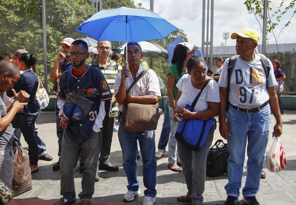 People wait for public transportation while the metro is out of service due to a blackout in Caracas, Venezuela, Tuesday, Aug. 20, 2019. The state electricity company reported on Twitter that a "breakdown" at an undisclosed location had caused the blackout and all power had been restored within hours, while opposition leader Juan Guaidó told local media that the outage was impacting at least 11 of Venezuela's 24 states. (AP Photo/Leonardo Fernandez)