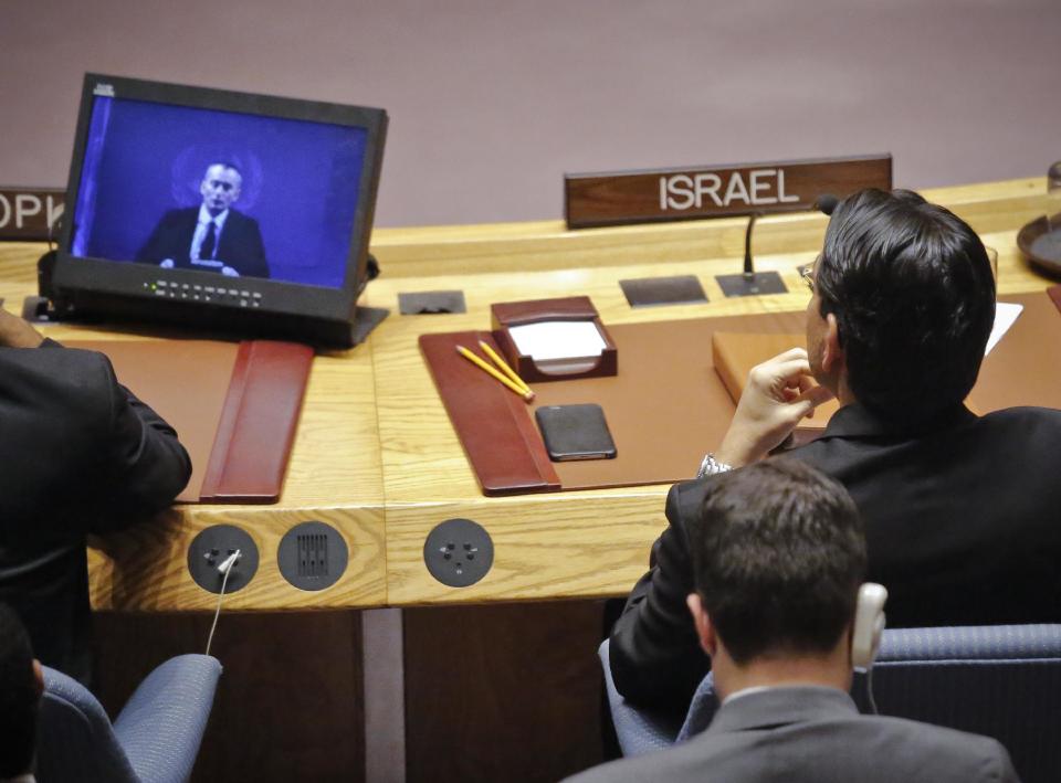 Israel U.N. Ambassador Danny Danon, right, watches a video broadcast of Nickolay Mladenov, United Nations Special Coordinator for the Middle East Peace Process, during a Security Council debate on the Middle East conflict Tuesday, Jan. 17, 2017 at U.N. headquarters. (AP Photo/Bebeto Matthews)