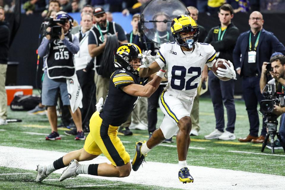 Michigan punt return Semaj Morgan runs against Iowa Iowa defensive back Koen Entringer during the first half of the Big Ten championship game at Lucas Oil Stadium in Indianapolis, Ind. on Saturday, Dec. 2, 2023.