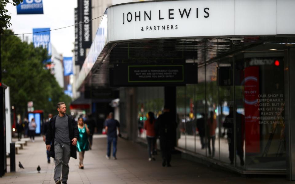 A man walks past the John Lewis & Partners store at the Oxford Street