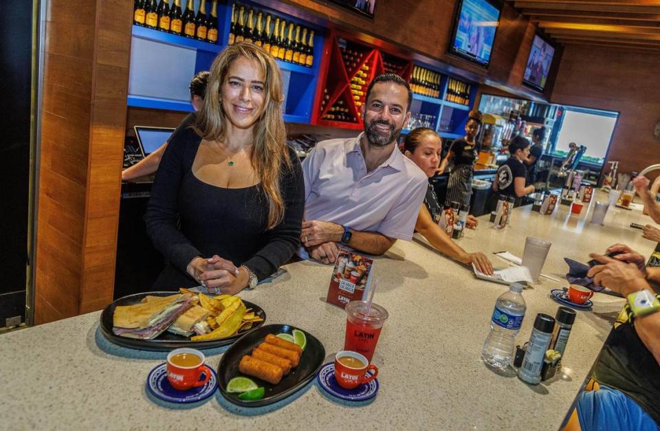 Publicist Mabel De Beunza and Owner-CEO Eric Castellanos display a selection of dishes from the menu at the Latin Cafe 2000 at 875 NW 42nd Ave. in Miami, on Friday September 22, 2023. Pedro Portal/pportal@miamiherald.com