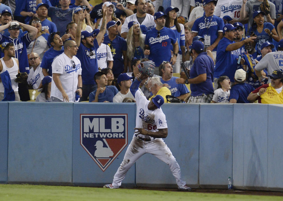 <p>Los Angeles Dodgers right fielder Yasiel Puig throws his glove after failing to catch a ball hit for a ground-rule double by Houston Astros third baseman Alex Bregman (not pictured) in the 8th inning in game two of the 2017 World Series at Dodger Stadium. Mandatory Credit: Gary A. Vasquez-USA TODAY Sports </p>