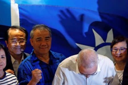 Wu Den-yih (2nd-R), newly elected chairman of Taiwan's opposition Nationalist Kuomintang Party (KMT), bows during a news conference in Taipei, Taiwan May 20, 2017. REUTERS/Tyrone Siu