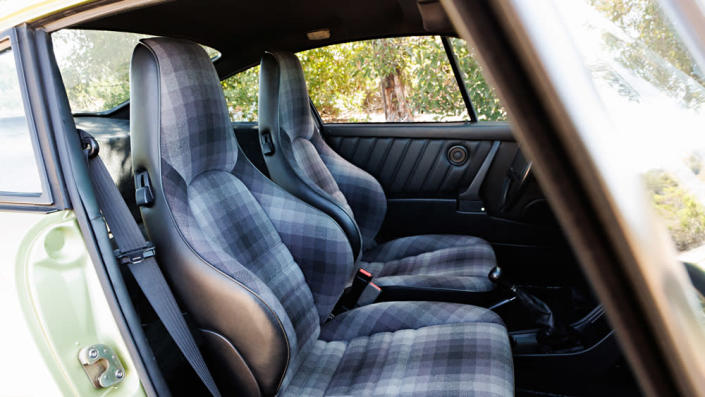 Porsche’s bygone “Celebration” upholstery, a two-tone cloth treatment in black and gray, adds to the exclusivity. - Credit: Brian Henniker, courtesy of Gooding &amp; Company.