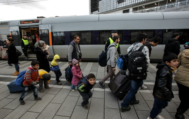 Migrants arrive on the platform at the Swedish end of the bridge between Sweden and Denmark in Malmo, Sweden, on November 12, 2015