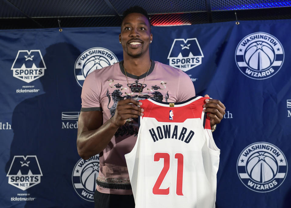 Dwight Howard poses with his Wizards jersey at Monday’s news conference. (AP)