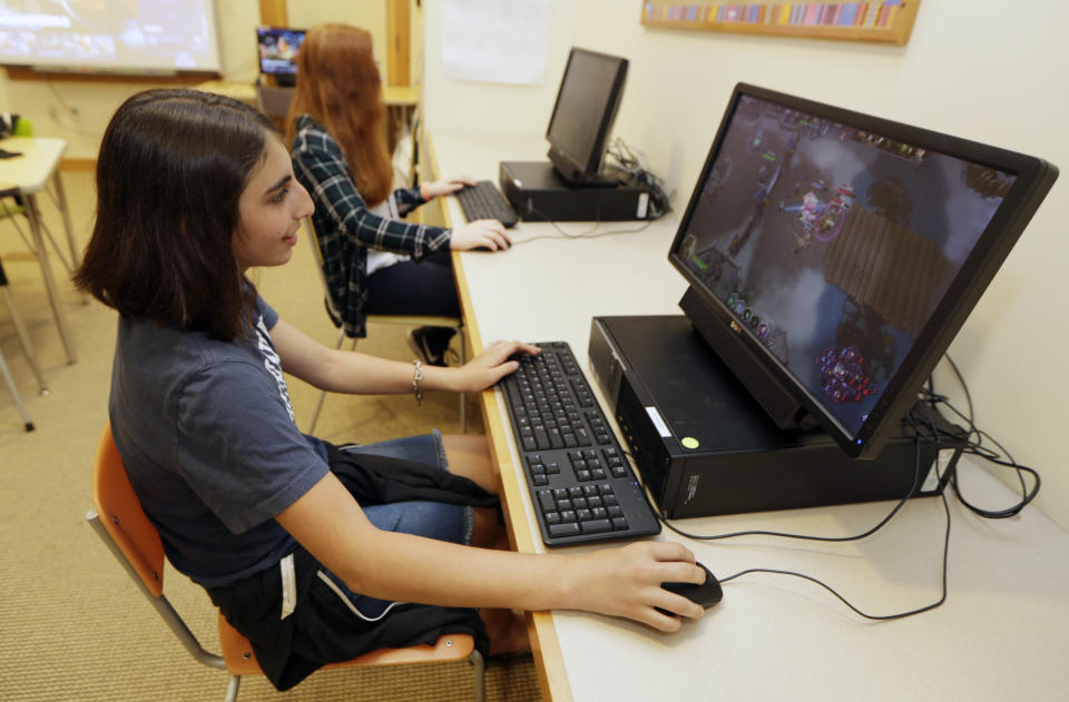 Kaila Morris, foreground, plays "Heroes of the Storm," at Hathaway Brown School, Wednesday, July 10, 2019, in Shaker Heights, Ohio. Hathaway Brown launched the country's first varsity esports program at an all-girls school. (AP Photo/Tony Dejak)