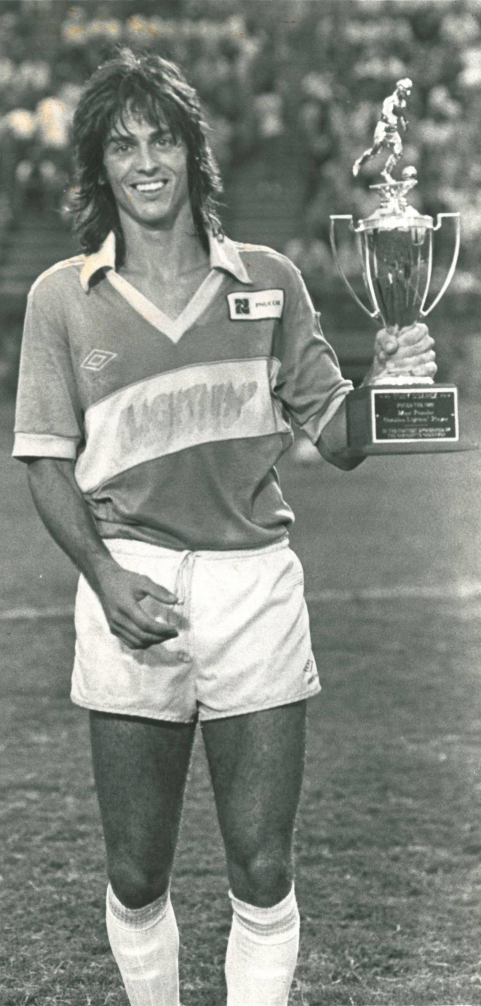 Tony Suarez holds a trophy he won with the Carolina Lightnin’ for being named the league’s rookie of the year in 1981. The Lightnin’ won the American Soccer League championship that year, with Suarez its leading scorer.