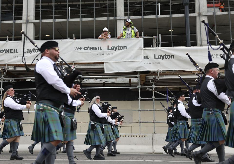 Construction workers watch as the Utah Pipe Band passes by during the Days of ‘47 Parade in Salt Lake City on Monday, July 24, 2023. | Laura Seitz, Deseret News