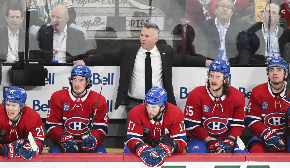 Montreal Canadiens head coach Martin St. Louis, top center, looks on from behind the bench during second-period NHL hockey game action against the Colorado Avalanche in Montreal, Monday, March 13, 2023. (Graham Hughes/The Canadian Press via AP)