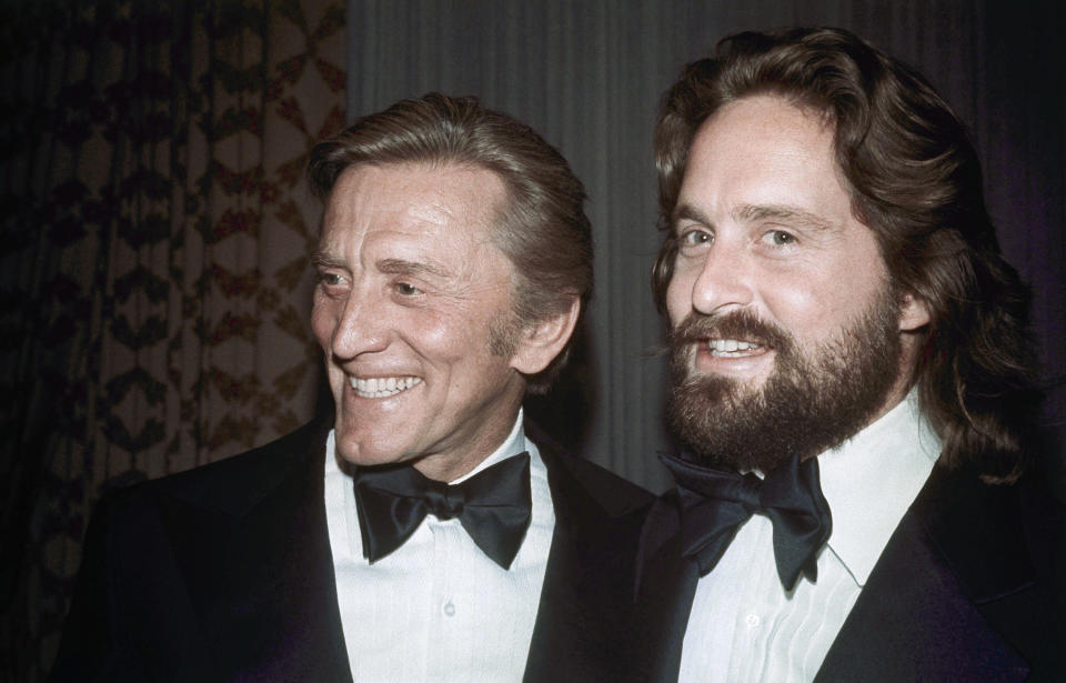 FILE - This 1976 file photo shows father-son actors Kirk Douglas, left, and Michael Douglas in New York. Kirk Douglas died Wednesday, Feb. 5, 2020 at age 103. (AP Photo, File)