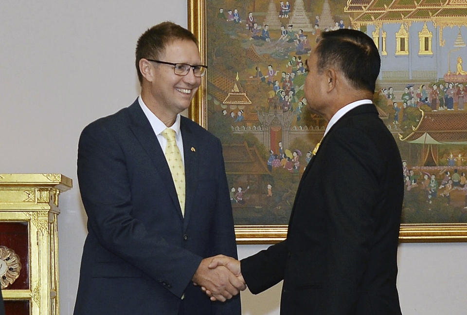 In this photo released by Government Spokesman Office, Richard Harris, left, an Australian member of the Thai cave rescue team, shakes hands with Thailand's Prime Minister Prayuth Chan-ocha after receiving the Member of the Most Admirable Order of the Direkgunabhorn during the royal decoration ceremony at the Royal Thai Government House in Bangkok, Thailand, Friday, April 19, 2019. Two Australian doctors, Harris and Craig Challen, received royal honors for helping rescue the Wild Boars soccer team from a flooded cave (Government Spokesman Office via AP)