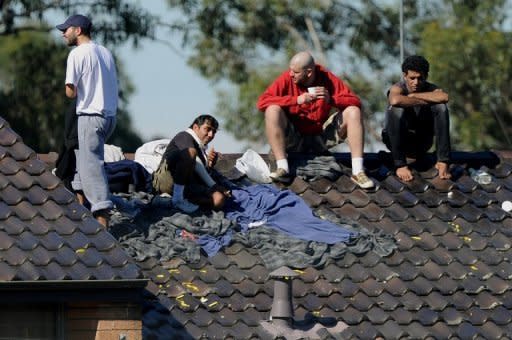 Asylum-seekers protest on top of a building at Sydney's Villawood Detention Centre in April. Australia's High Court has dealt a heavy blow to the government by blocking its plans to send asylum-seekers to Malaysia, ruling they could not go to a nation lacking legal safeguards