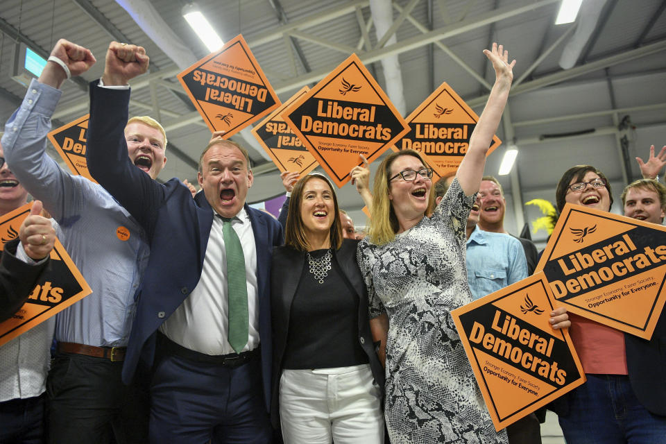 Liberal Democrats' Jane Dodds, centre, celebrates with supporters as she wins the seat in the Brecon and Radnorshire by-election at the Royal Welsh Showground in Llanelwedd, Builth Wells, Wales Friday, Aug. 2, 2019. After a first week in office that saw him booed in Scotland and berated in Belfast, British Prime Minister Boris Johnson was facing his first electoral test on Thursday, a special election that could see his Conservative government's working majority in Parliament cut to just one vote. (Ben Birchall/PA via AP)