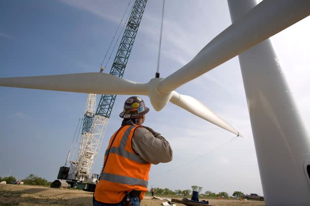 A 300-foot crane slowly lifts a rotor onto a tower on the Lone Star Wind Farm near Abilene, Texas. (Photo: Robert Nickelsberg via Getty Images)