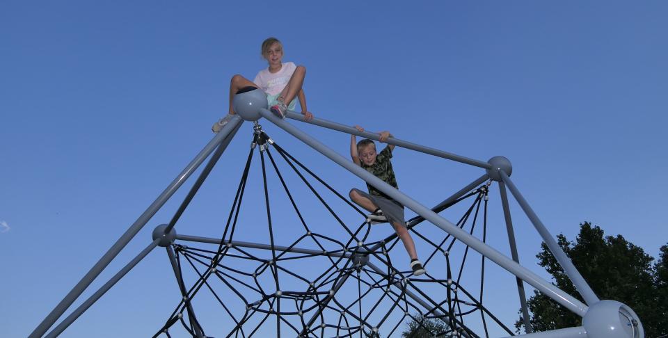 Aubrey, 10, and Sam, 8, Collier enjoy Olivia's Playground on Aug. 15 in Salina.