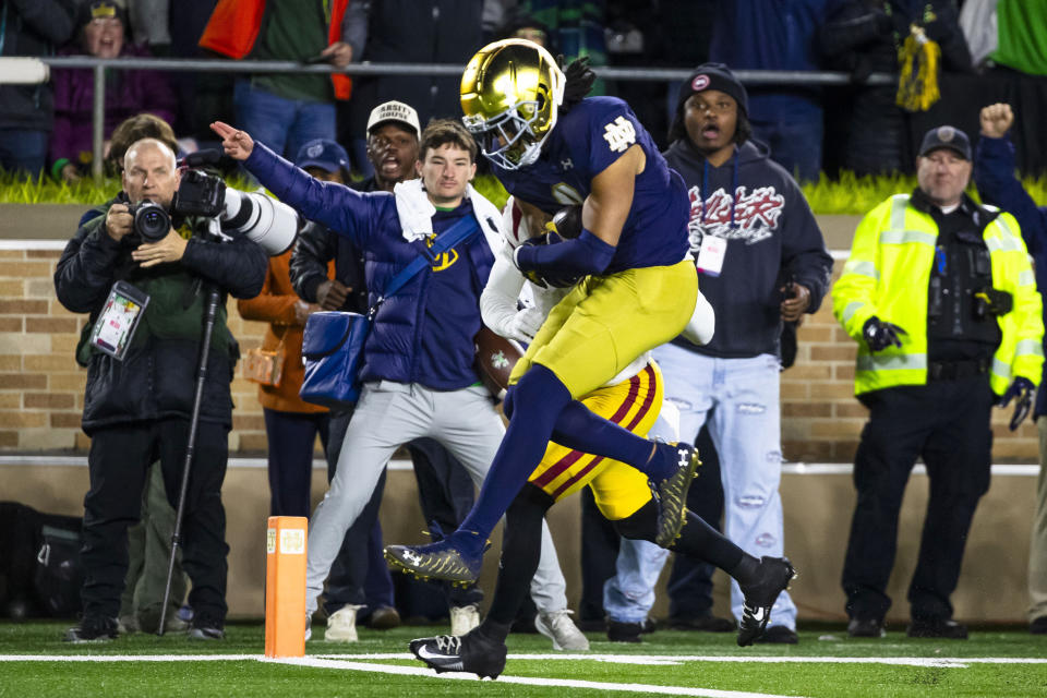 Notre Dame safety Xavier Watts (0) jumps into the end zone to score a touchdown after recovering a fumble during the second half of an NCAA college football game against Southern California Saturday, Oct. 14, 2023, in South Bend, Ind. (AP Photo/Michael Caterina)