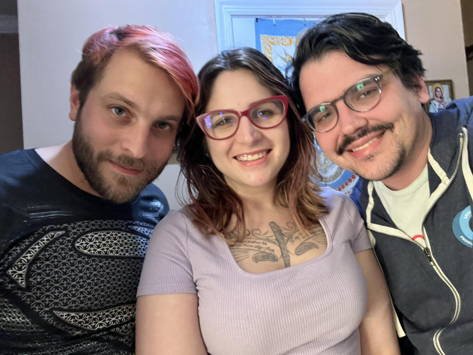Jennifer Martin, pictured with her husband and her partner, who all live in the same house and are raising their two children. (Courtesy Jennifer Martin)